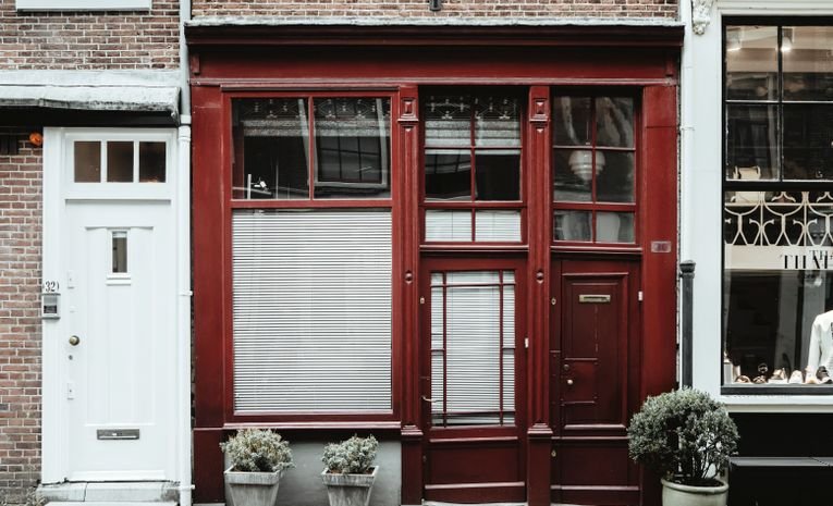 Charming red brick shop storefront on a quiet street, representing business rates for small business premises in the UK