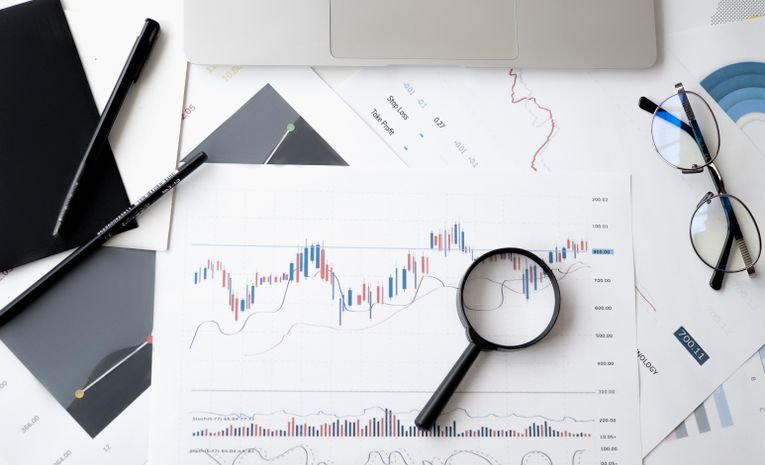 Person calculating product costs and profit margins with a calculator and price tags, representing pricing a product for profit